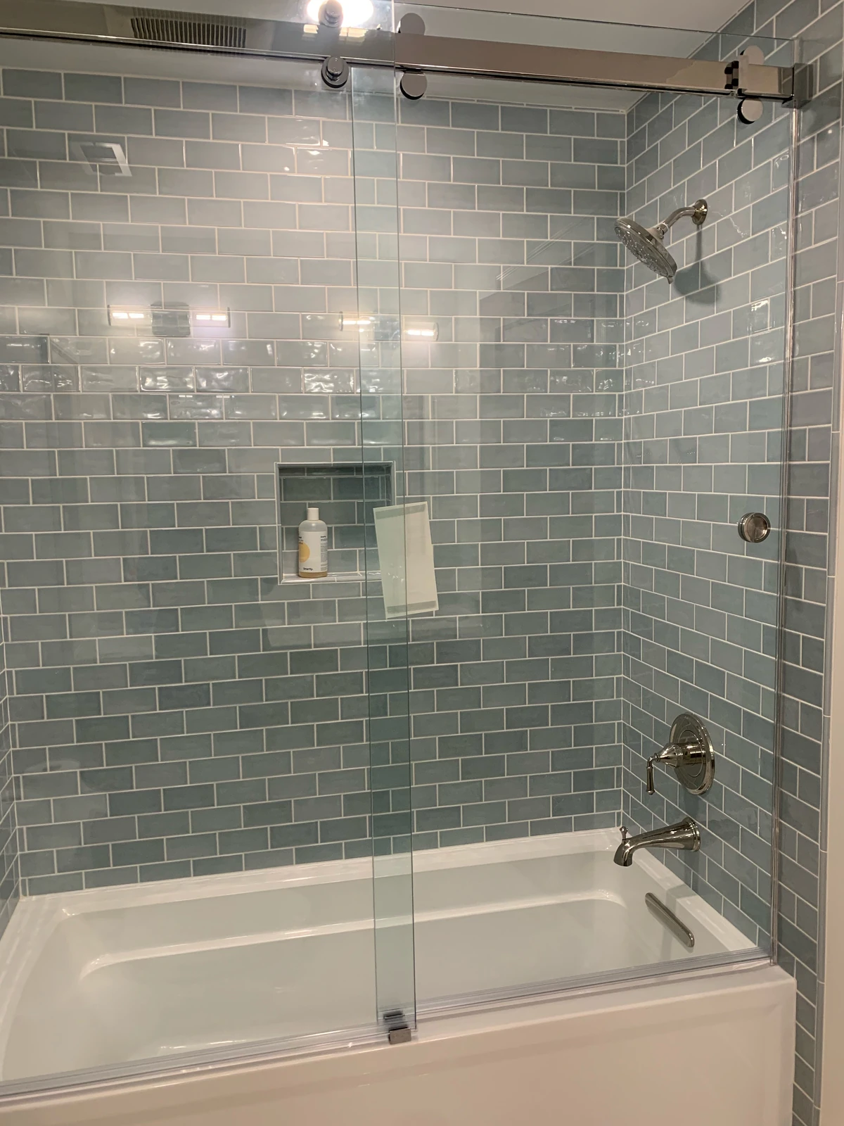 Blue subway tile tub and shower