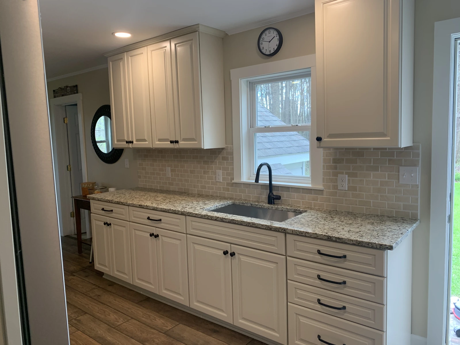 White cabinet kitchen with cream tile backsplash