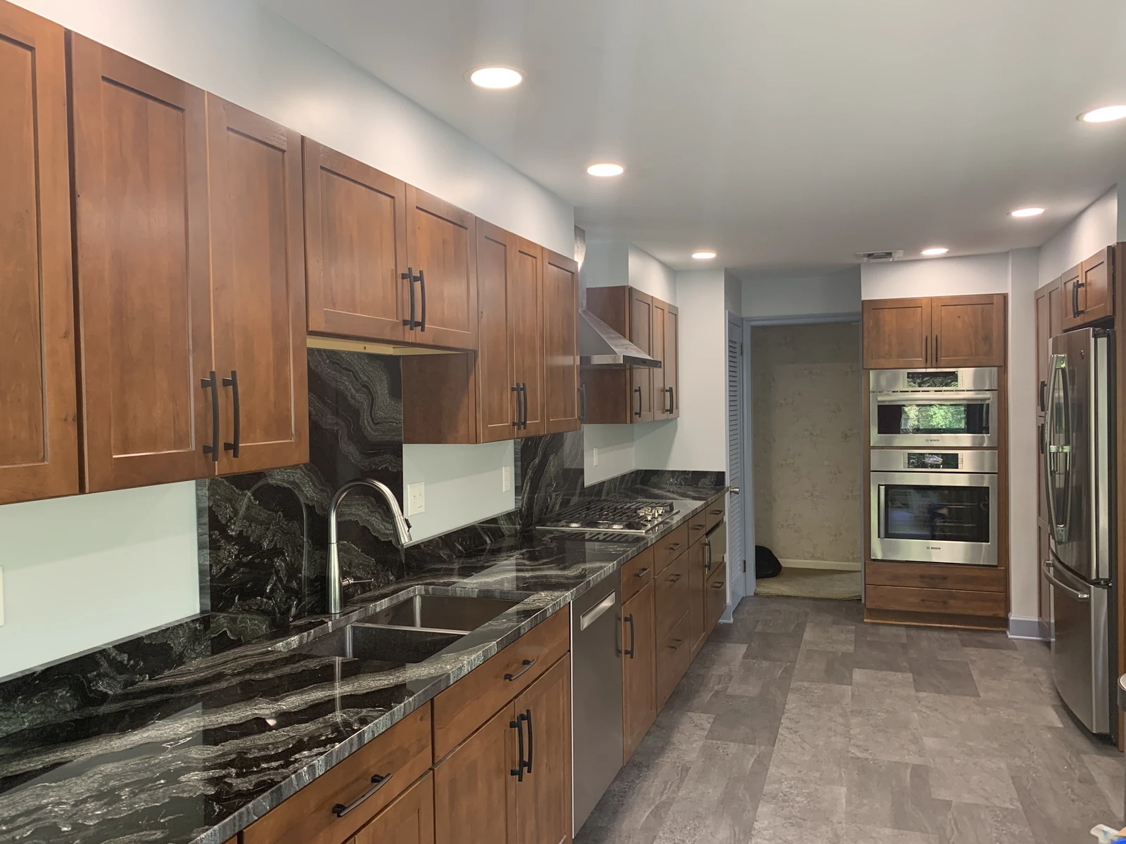 Walnut cabinet kitchen with dark granite