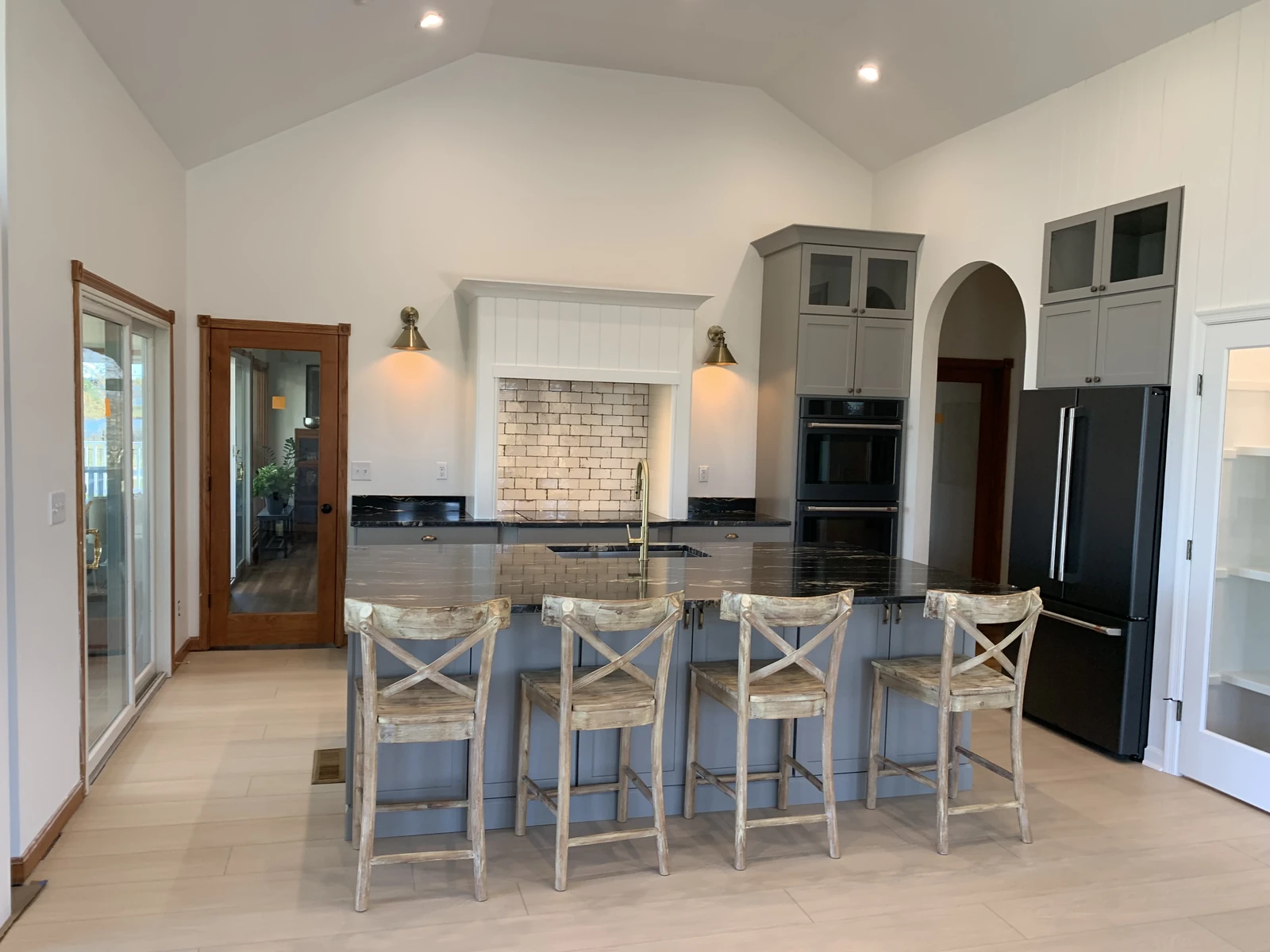 Gray island kitchen with vaulted ceiling