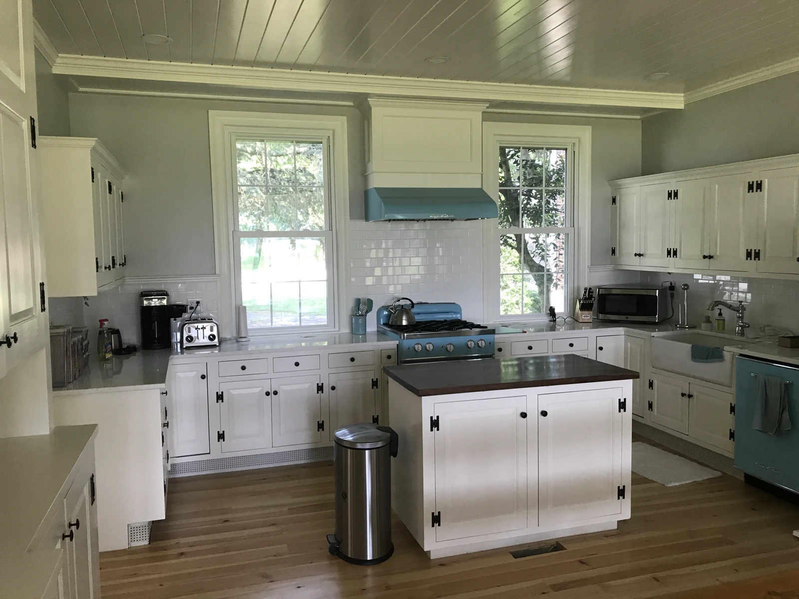 Same kitchen after white spray cabinets and blue range