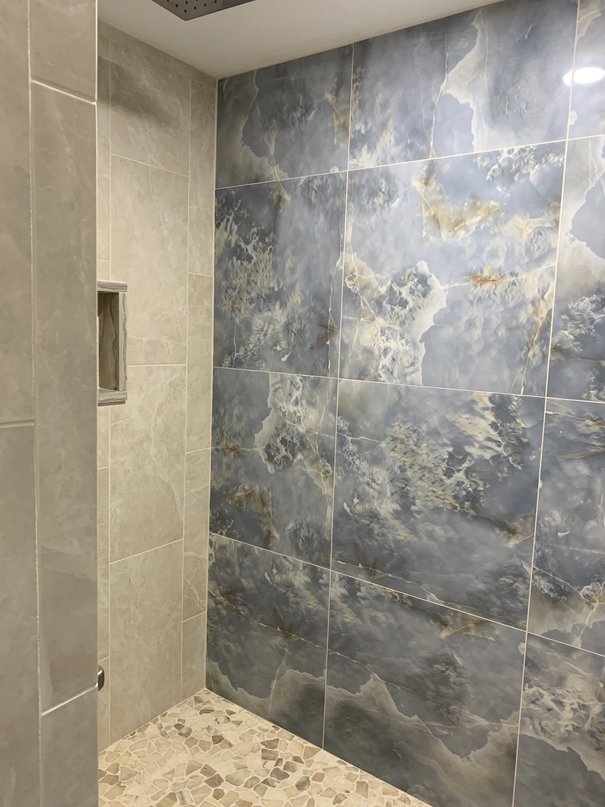 Marble-look tile shower wall