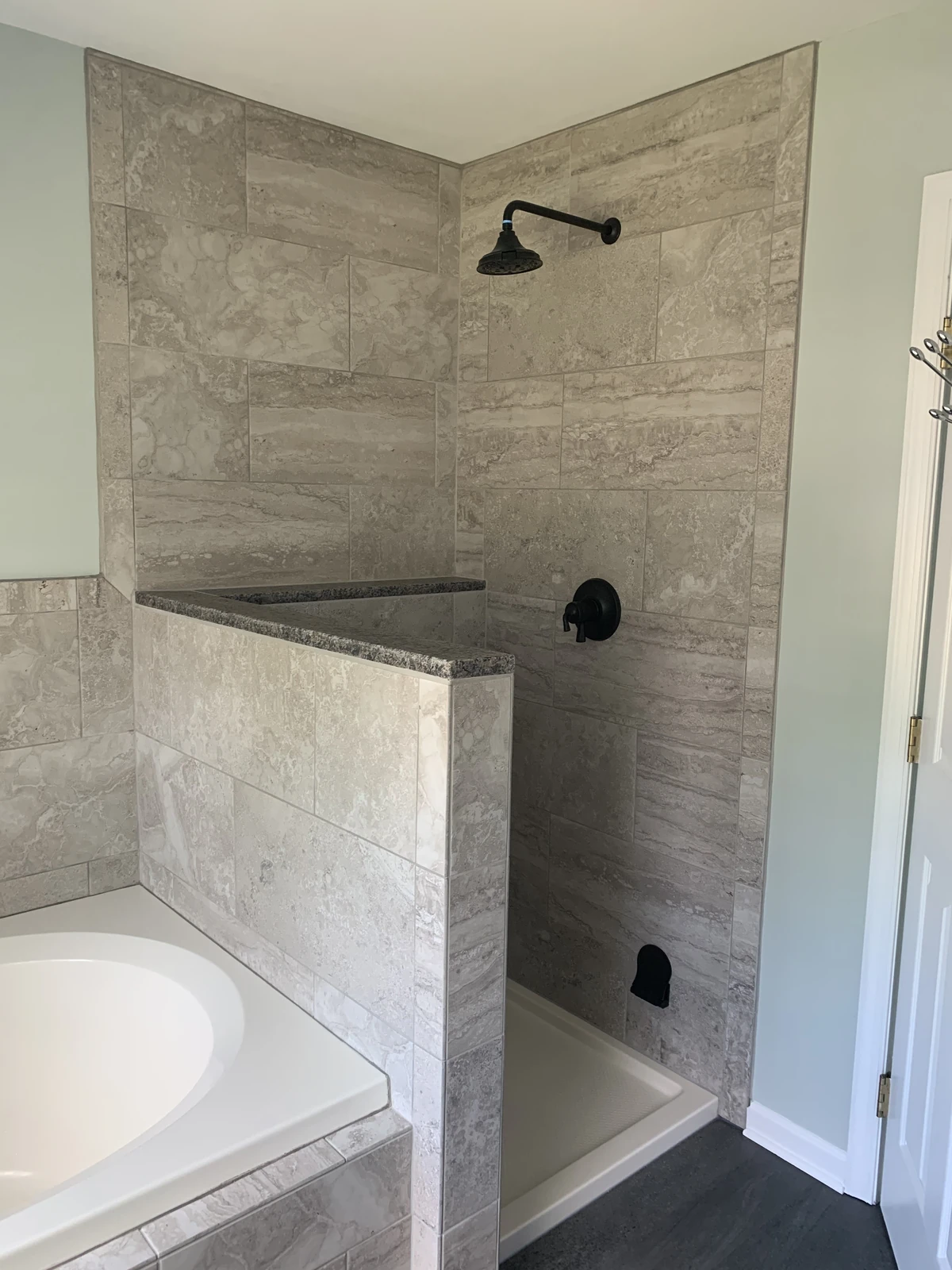 Walk-in tile shower next to tub